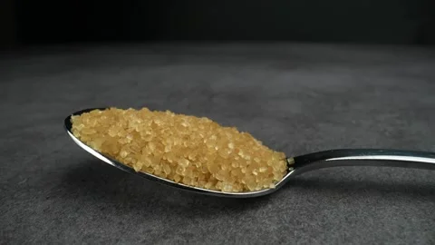Brown Sugar in a spoon on a table Stock Footage 249970805
