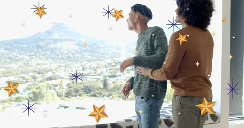 Brown-sweater man approaching embracing partner at window sharing valley view Stock Footage 323335065