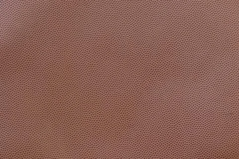 Brown synthetic leather embossed in small dots for background Stock Photos