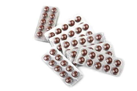 Brown tablets in blister Stock Photos