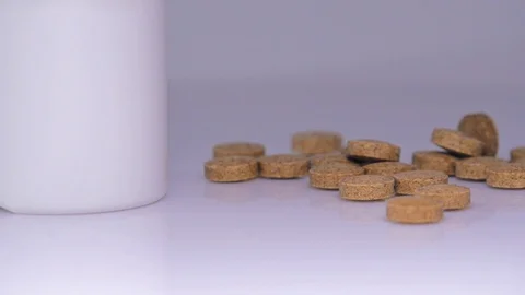 Brown tablets. rotation on a white background Stock Footage 129607060
