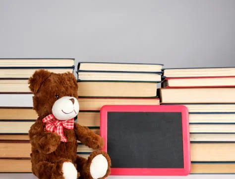 Brown teddy bear and empty black board in red frame Stock-Fotos