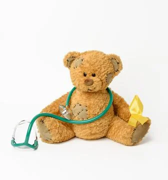 Brown teddy bear with a patch,  silk yellow ribbon in the shape of a loop Stock Photos