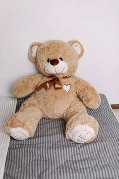 Brown teddy bear sitting on bed no people Stock Photos