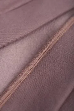 Brown textile with seam. Inner loop seam of clothing. Stock Photos