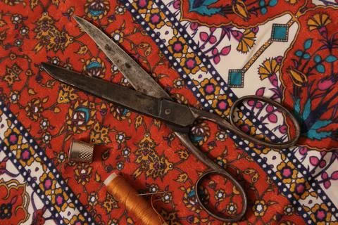 Brown Thread With Thimble and Scissors on Vintage Fabric Stock Photos