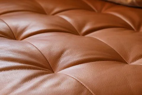 Brown tufted leather upholstery texture with diamond pattern, luxurious furni Stock Photos
