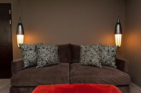 Brown two seated sofa dark ambience Stock-Fotos