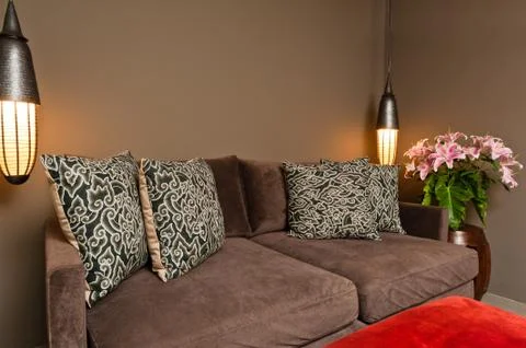 Brown two seated sofa dark ambience Stock Photos