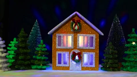 Brown two-story house decorated with a Christmas wreath among colorful fir trees Stock-Footage 291069126