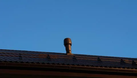 Brown vent stack on a roof of a house. Foto stock