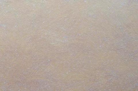 Brown wall decorated with a solution of clay with white patches. Stock Photos
