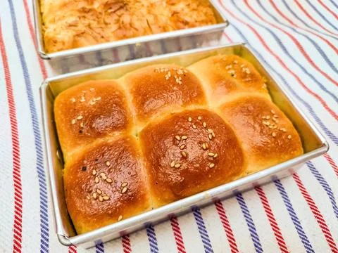 A brown wheat bakery bread sprinkled with cedar cheese and sesame isolated .. Stock Photos