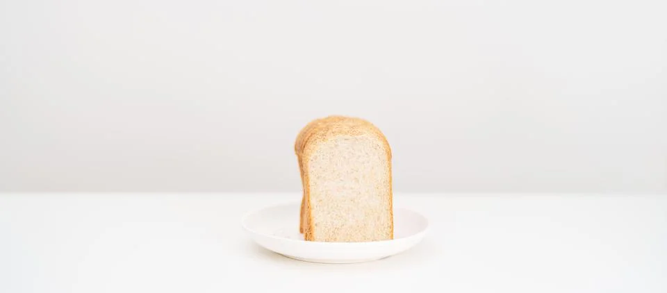 Brown whole wheat bread slice on plate. Weight loss management, Dieting, He.. Stock Photos