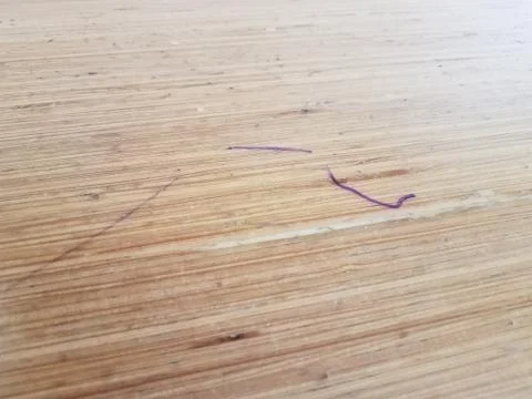 Brown wood table with purple ink marks Stock Photos