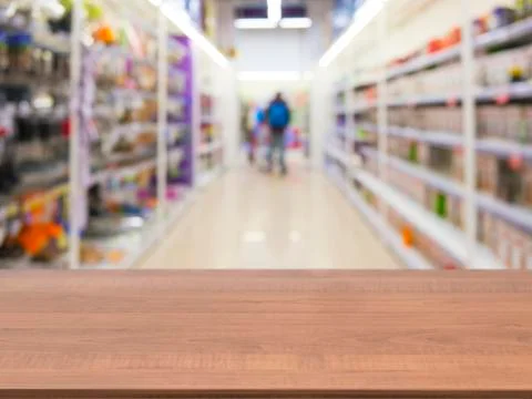Brown wooden empty table in front of blurred supermarket Stock Photos