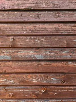 Brown wooden plank wall with weathered old paint Stock Photos