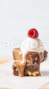 Brownie with nuts, chocolate and ice cream. Grey background Stock Photos