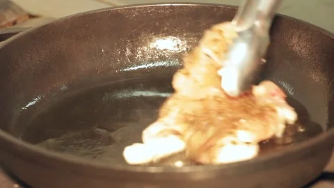 Browning meat in a pan with butter Stock Footage 72425244