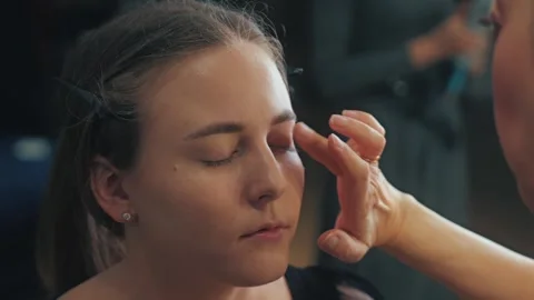 Brows are shaped with a fine brush and tinted gel. Arches lift and frame Stock Footage 308468905