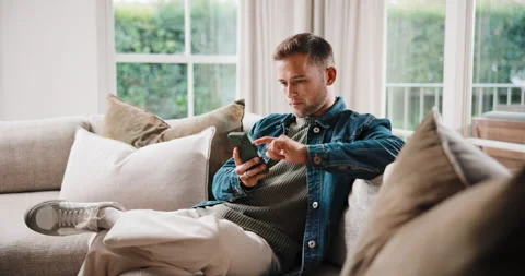 Browse, reading and man on sofa with phone, web search and online chat on social Stock Footage 341396437