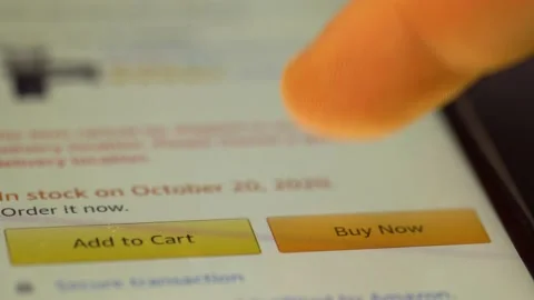 Browsing In Amazon Website And Clicks On Buy Now - macro Video stock 143922546