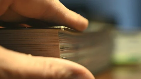  browsing an angle of a book with thumb of male hand Stock Footage 104851099