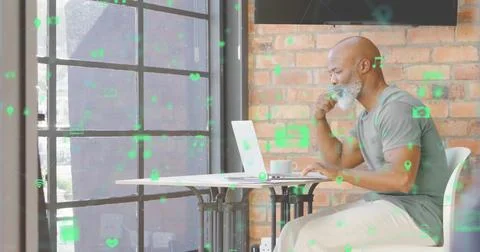 Browsing bearded man checking laptop while sipping coffee at cafe, with icon Foto stock