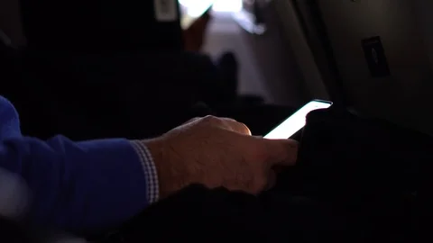 Browsing Cellphone During Airplane Pre-Flight Waiting Time Stock Footage 107945283
