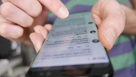Browsing comments Left by Users on a Social Media app on a Smartphone Stock-Footage 145494784