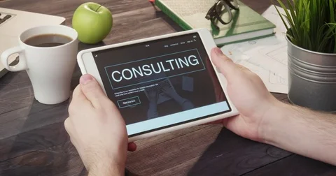 Browsing consulting web page using digital tablet at desk Stock Footage