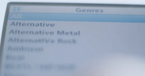 Browsing genre playlists on a digital mp3 player - music listening macro close-u Video stock 129307554