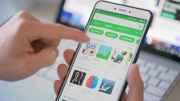 Browsing the Google Play Store on a smartphone Stock Footage 86143981