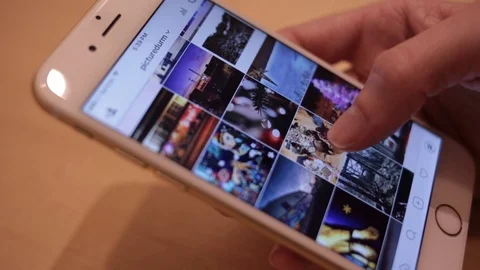 Browsing Instagram photos on iPhone Video stock 102187795