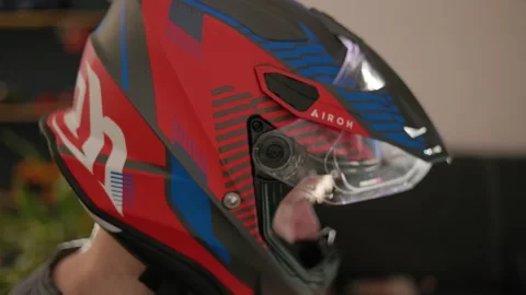 Browsing internet, watching tv with motorcycle helmet on head 動画素材 273137727