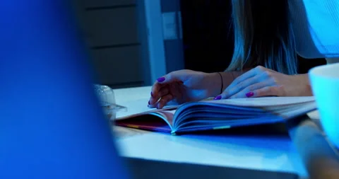 Browsing the magazine in a blue ambient light by a girl. Stock Footage 150268159