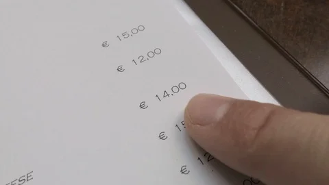 Browsing the menu in the restaurant with finger, prices Stock Footage 89877221