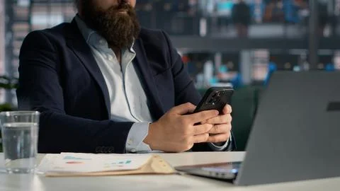Browsing mobile apps as addictive habit and office work distraction Stock Photos