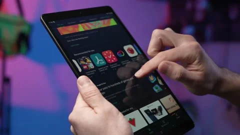 Browsing New Mobile Apps and Games To Download on a Tablet Computer Stock Footage 169542558