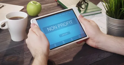 Browsing non profit internet page using digital tablet at desk Stock-Footage 80720853