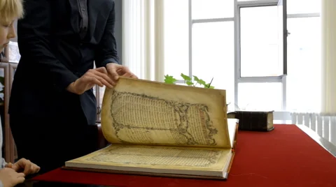 Browsing the old book Stock-Footage 42613354