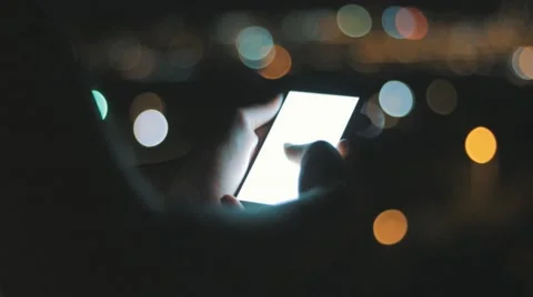 Browsing on Phone (w/ alpha) in front of urban city lights Stock-Footage 62077098
