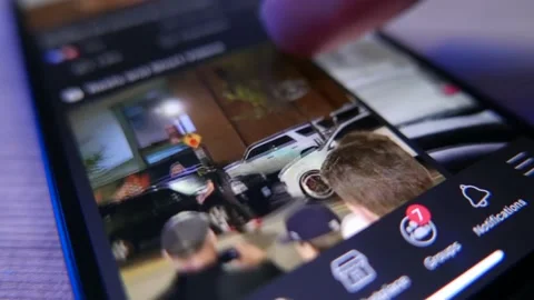 Browsing Posts on Facebook App on a Smart Phone Video stock 164414554