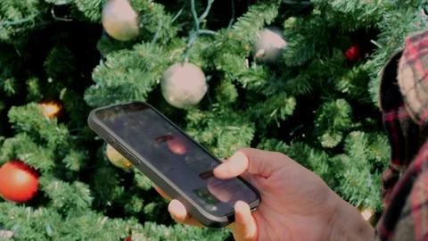 Browsing scrolling screen to choose gifts for Christmas, using... Stock Footage 323733052