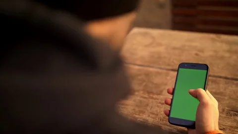 Browsing on a smartphone outside on a chilly day 4k chroma key Stock Footage 84688695