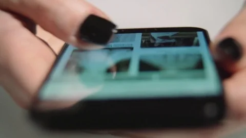 Browsing wedding dresses on a phone Stock Footage 85434749