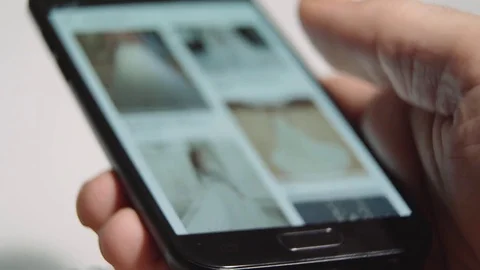 Browsing wedding dresses on a phone Stock Footage 85434769