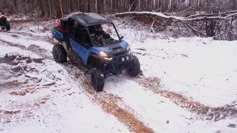 BRP Can-Am Commander overcomes the obstacle in forest with man in wellow helmet Stock Footage 177335397