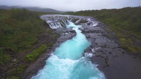Bruarfoss Raining Waterfall River in Iceland. Wide View Moody Fog Clouds Wide Stock Footage 257100019
