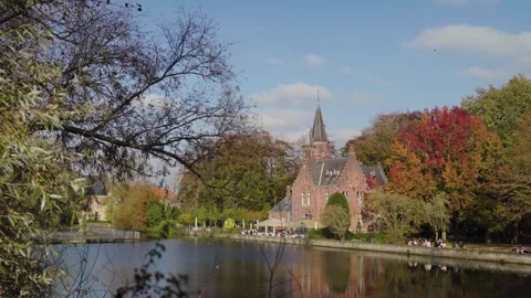 Bruges Belgium sunny day in fall with castle reveal on lake Video stock 329052530